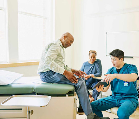 Nurse showing patient image on tablet