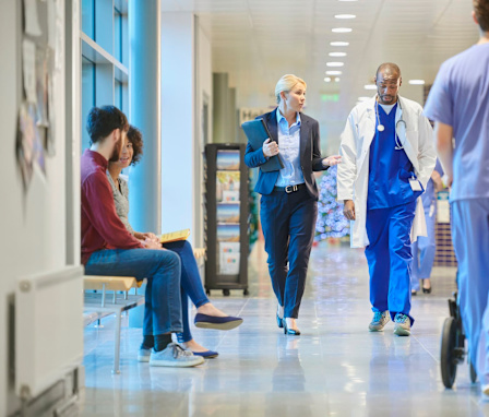 CNO talking to nurse in hospital hallway
