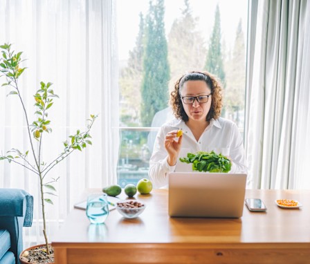 Nutritionist in telehealth meeting showing foods