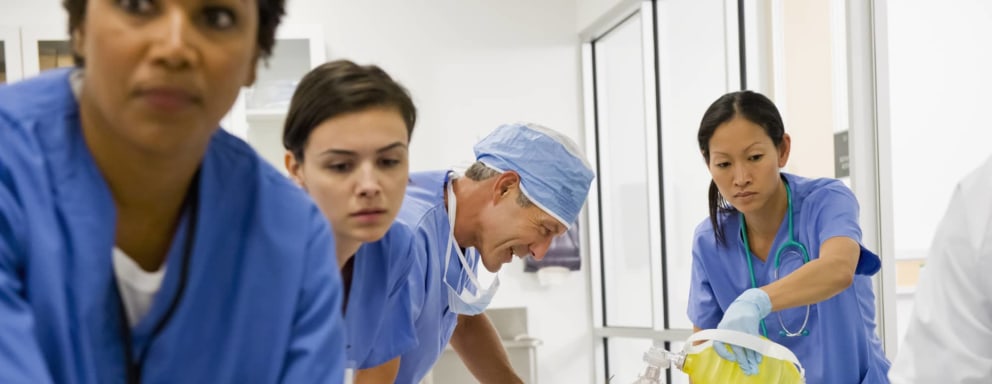 Nurses and doctor working together on a patient lying down