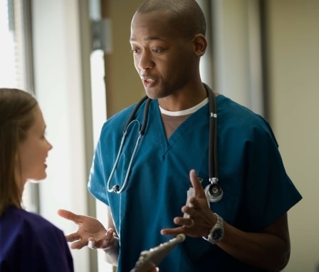 Male nurse advising female nurse