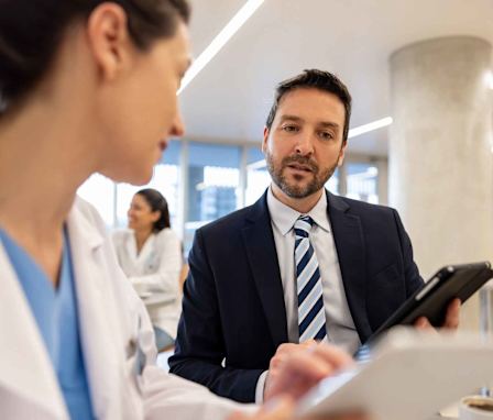 Healthcare administrator speaking to doctor