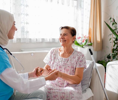 Hospice care nurse helping patient