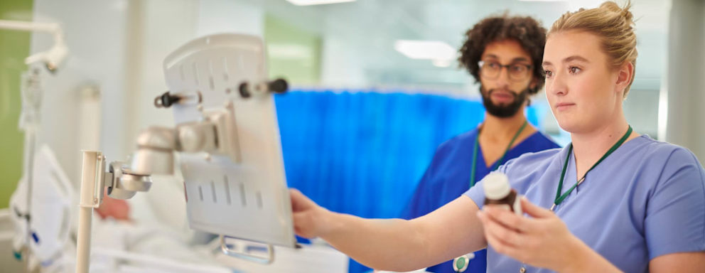 Nurse prescribing medication to patient
