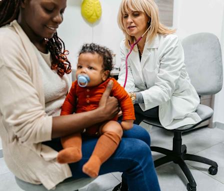 Pediatric nurse listening to baby breathing