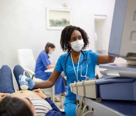 Pregnant patient getting an ultrasound by tech